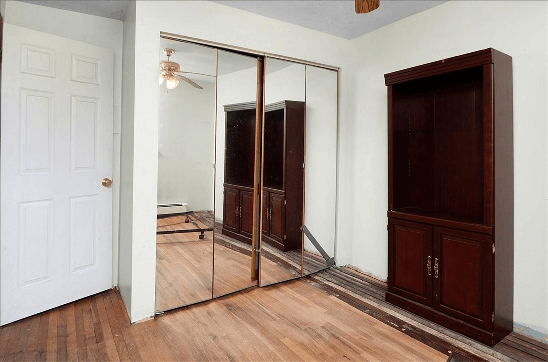 bedroom with mirrored closet doors