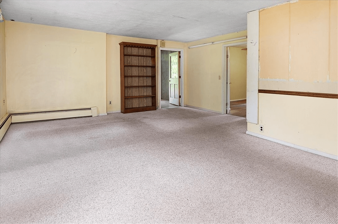 room with carpet and baseboard heat