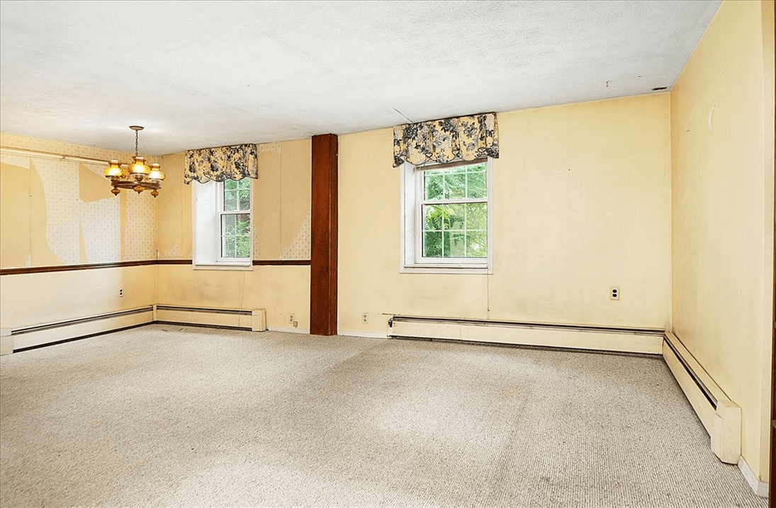room with carpet and baseboard heat
