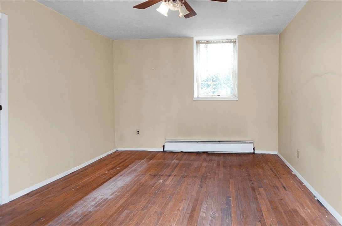 room with ceiling fan and baseboard heat