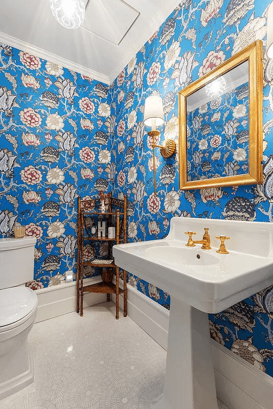 powder room with bold floral wallpaper and white fixtures