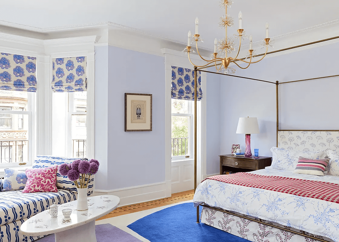third floor bedroom with blue walls and bay window
