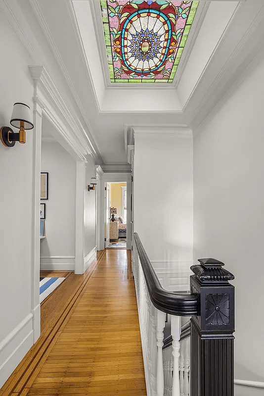 top floor hallway with stained glass skylight