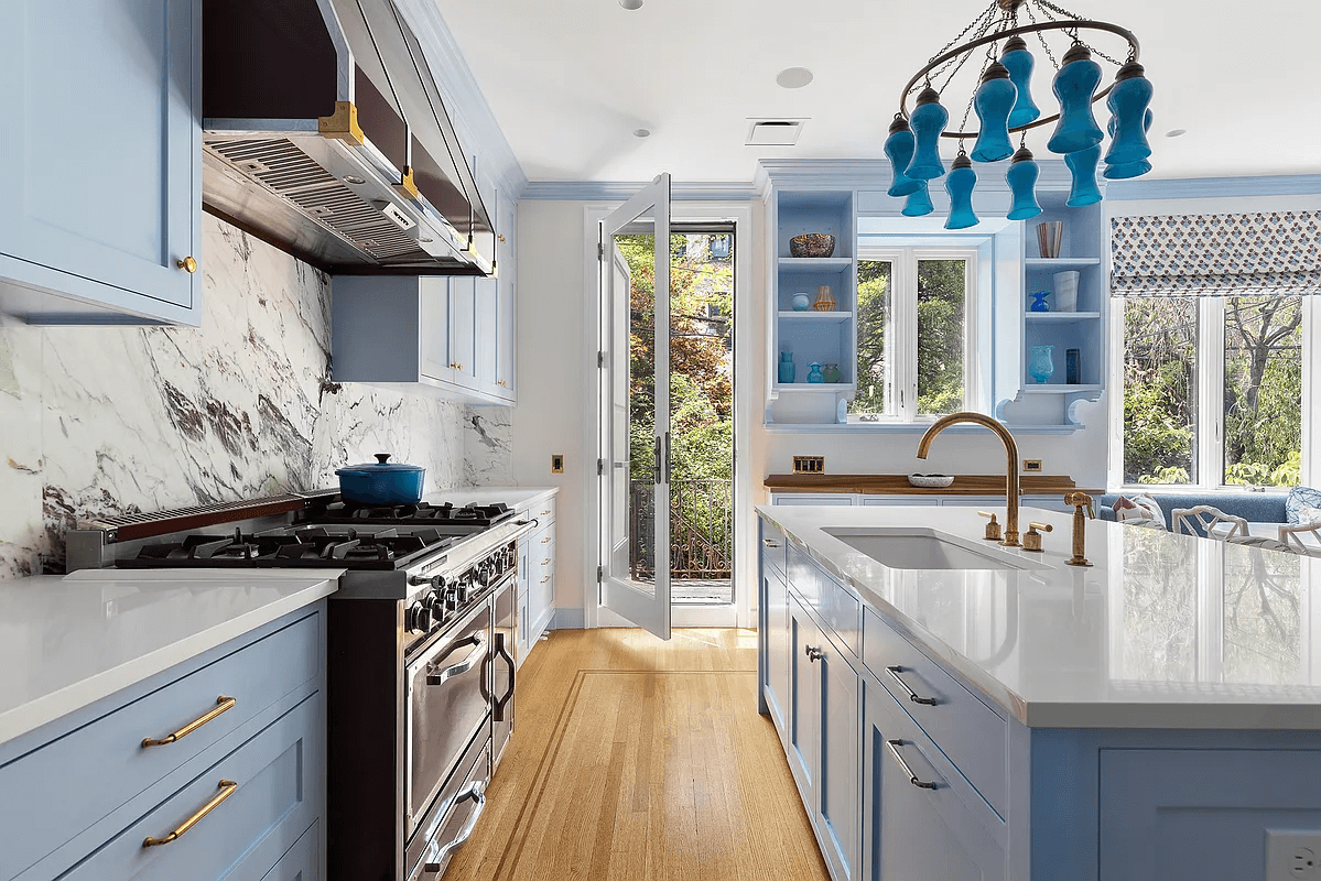kitchen with blue cabinets and door to rear yard