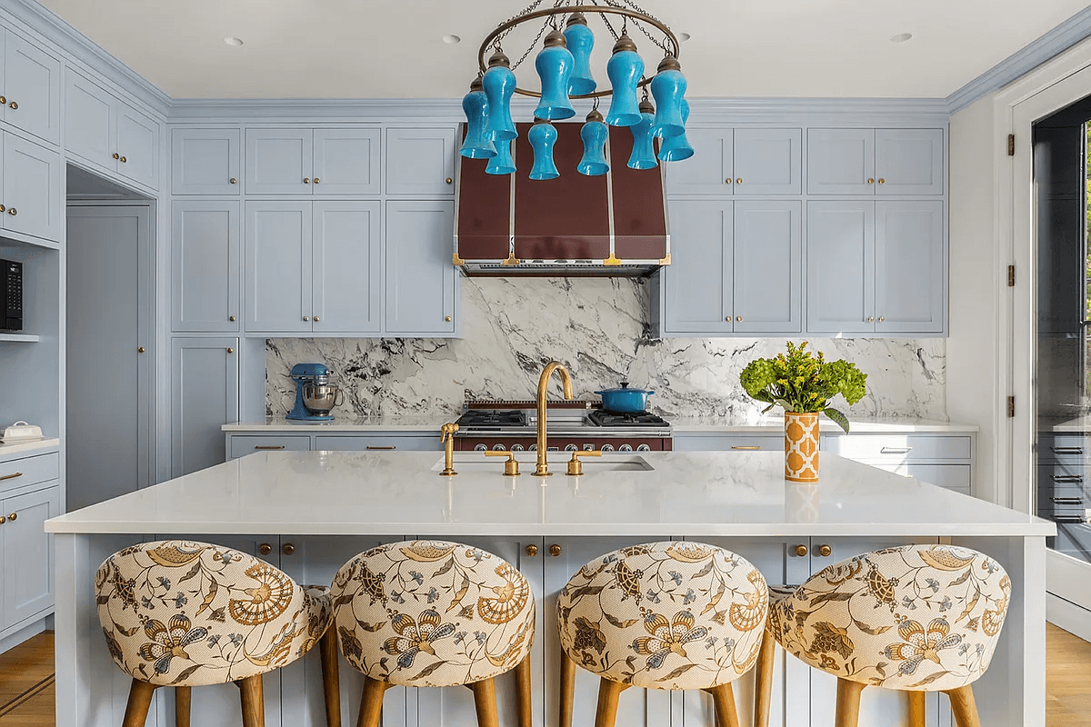 blue cabinets and large center island in the kitchen