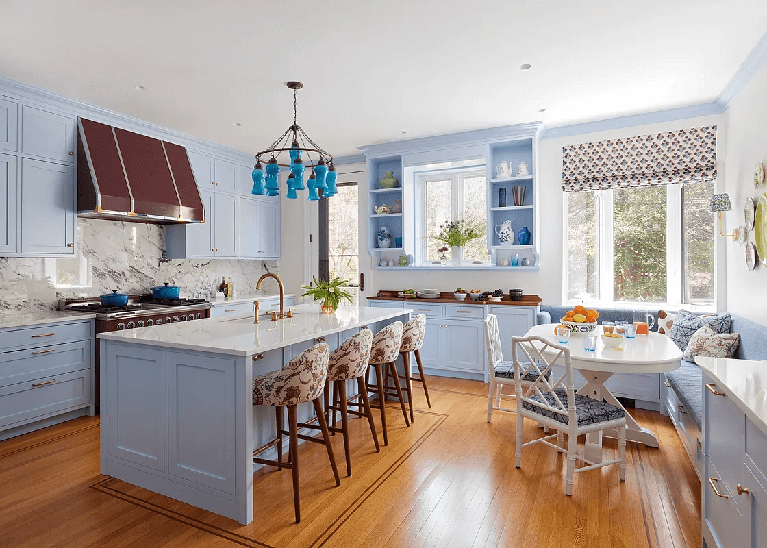 kitchen with blue cabinets, a large island and a banquette