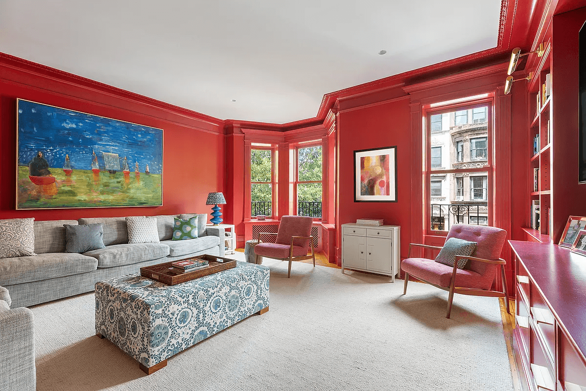 living room with red walls and built-in shelves