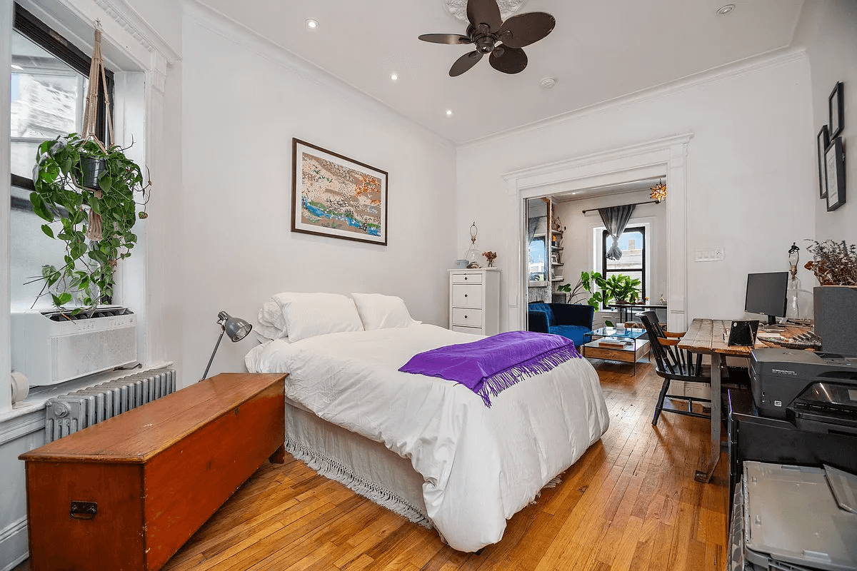 bedrom with recessed lighting and view into living room