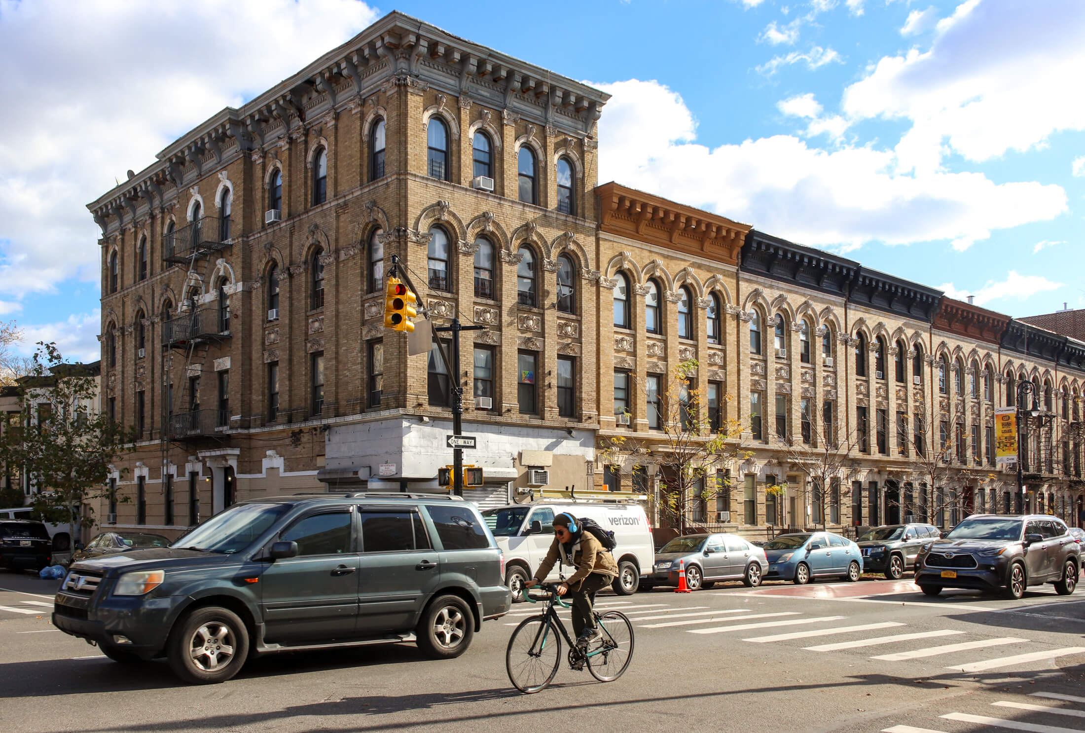 a biker cycling by buildings on rogers avenue