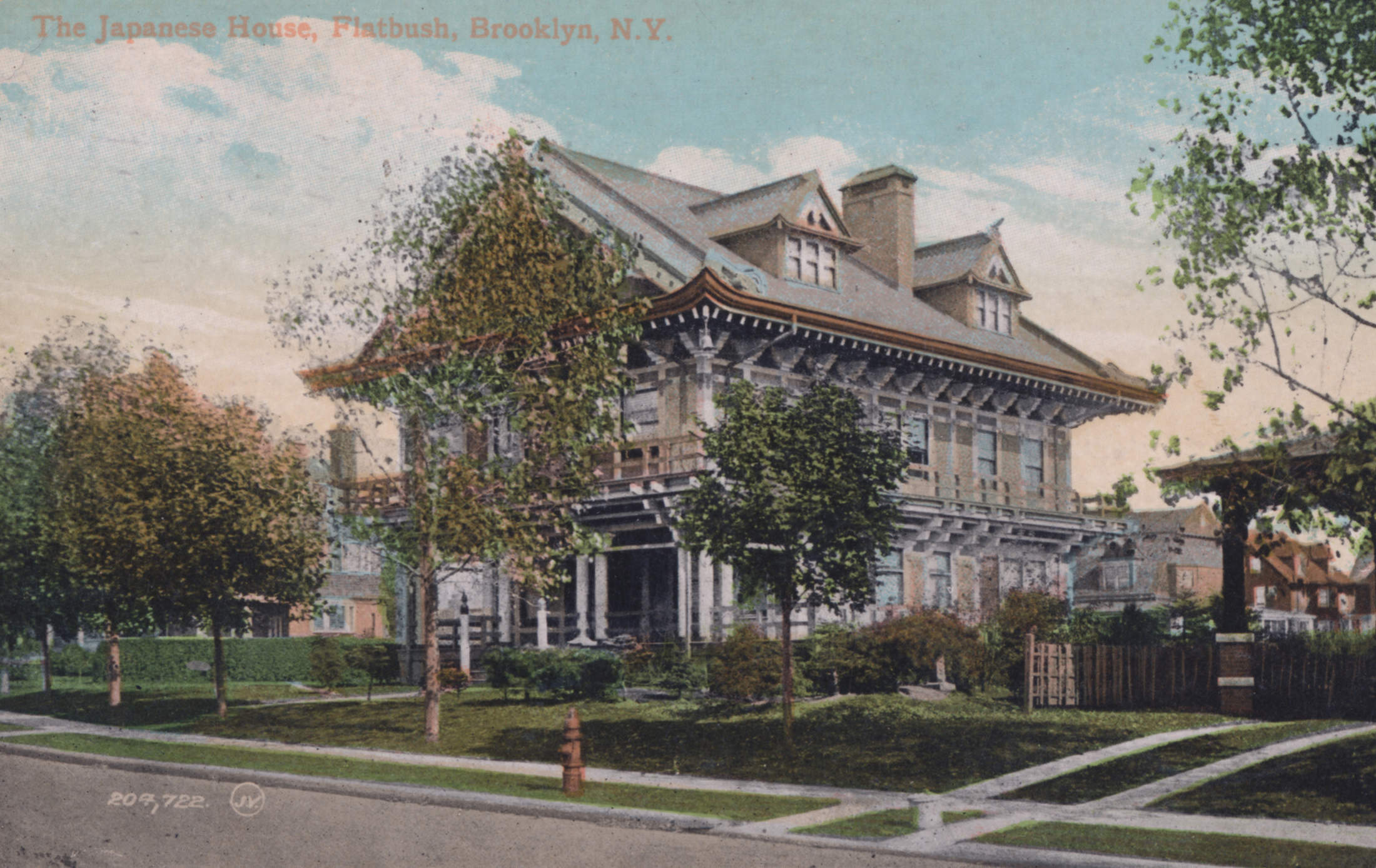 a colored postcard showing the house with a few trees and a lawn