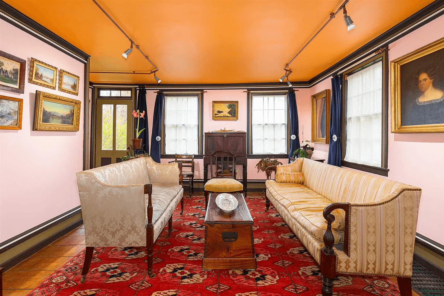 parlor with pink walls and orange ceiling