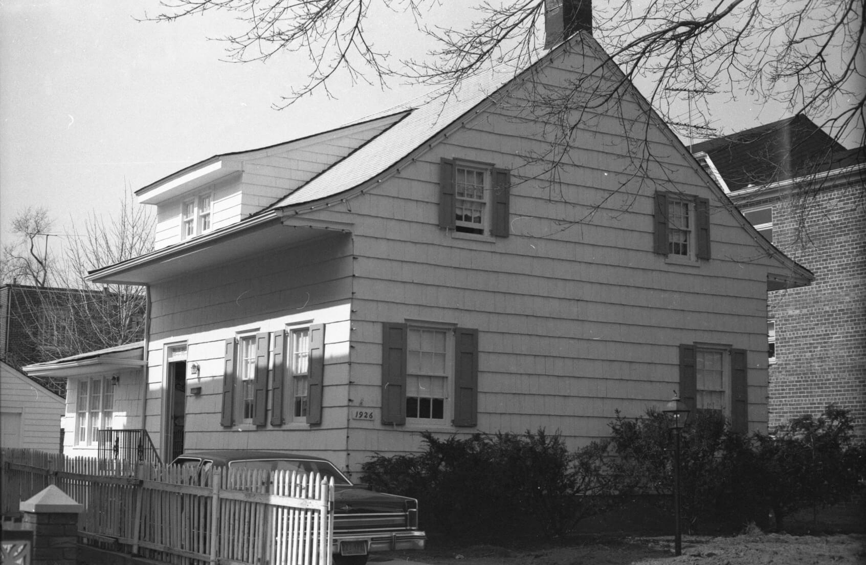 black and white photo of the wood frame house