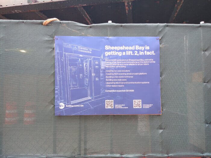 sign with information about the elevator project posted on the construction fence