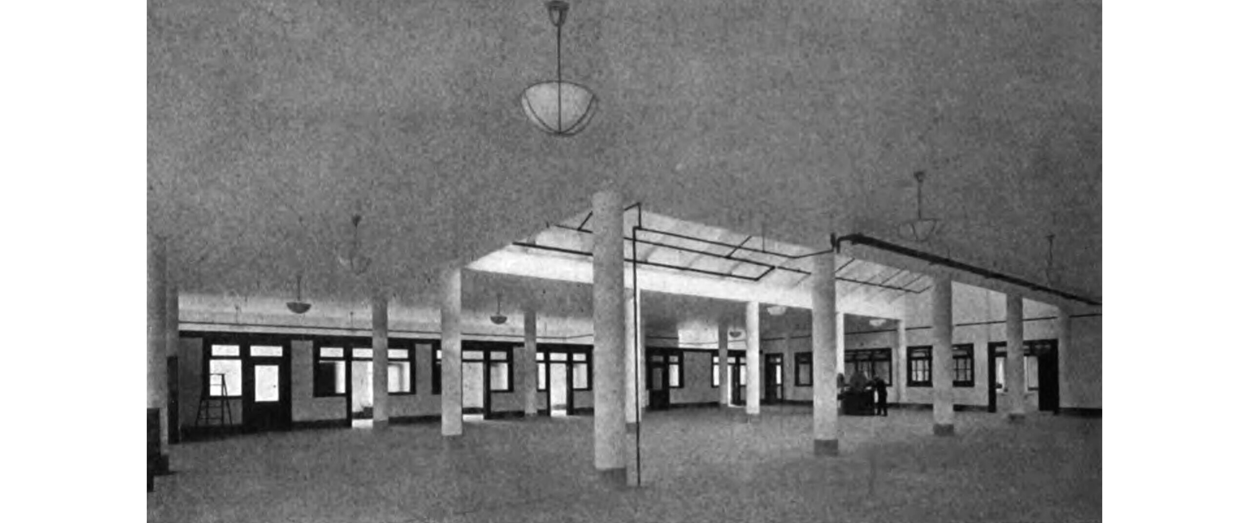 a black and white image of the columned interior of the building