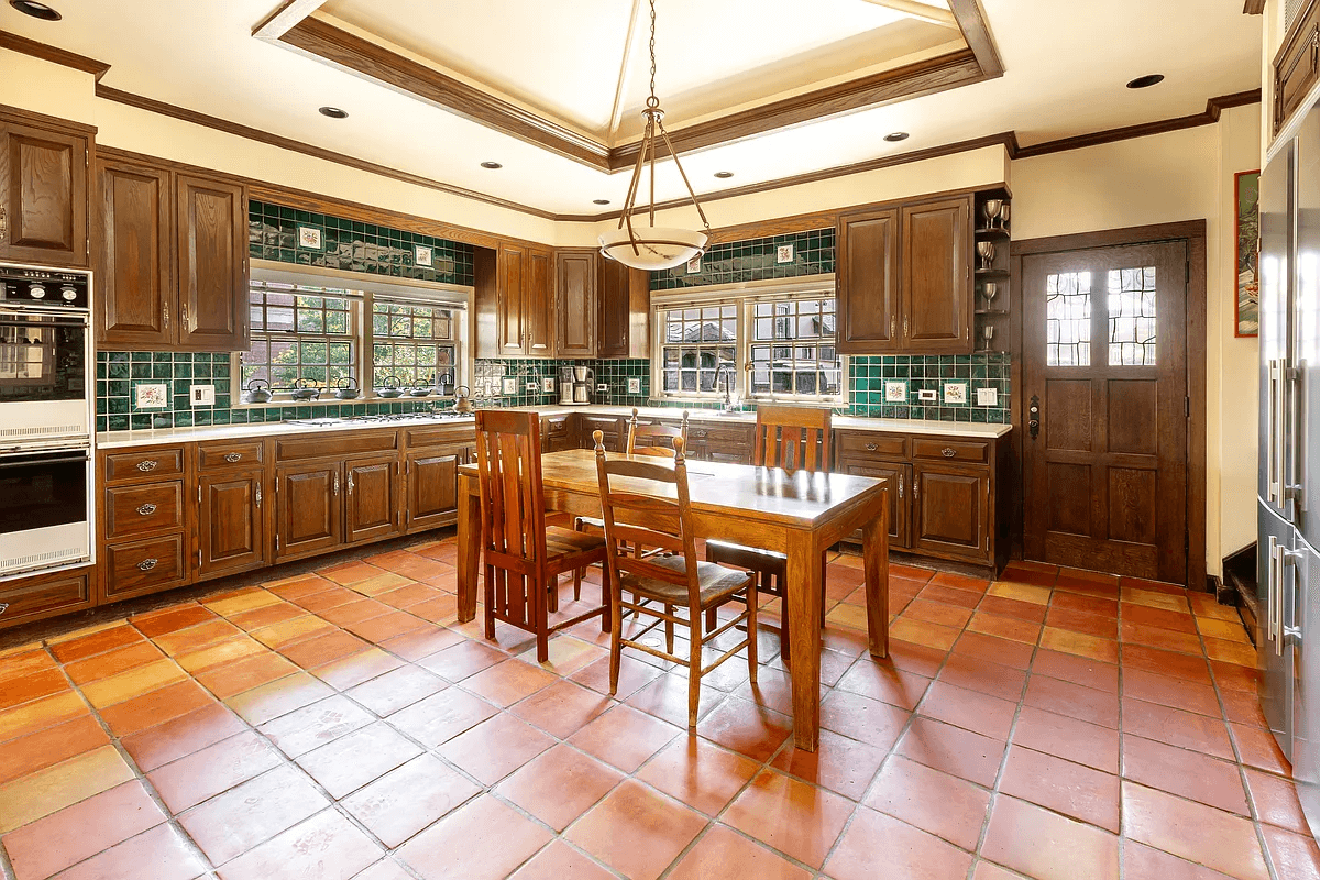 kitchen with terra cotta tile floors and wood cabinets