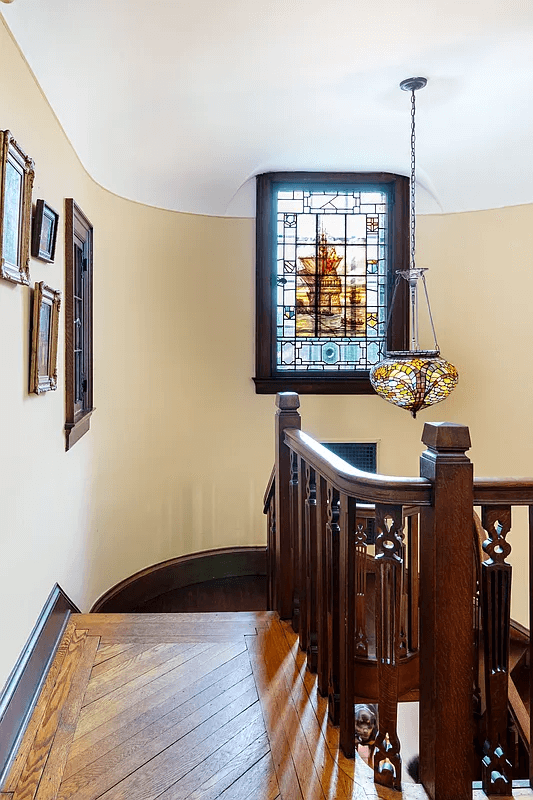 stair landing with stained glass window