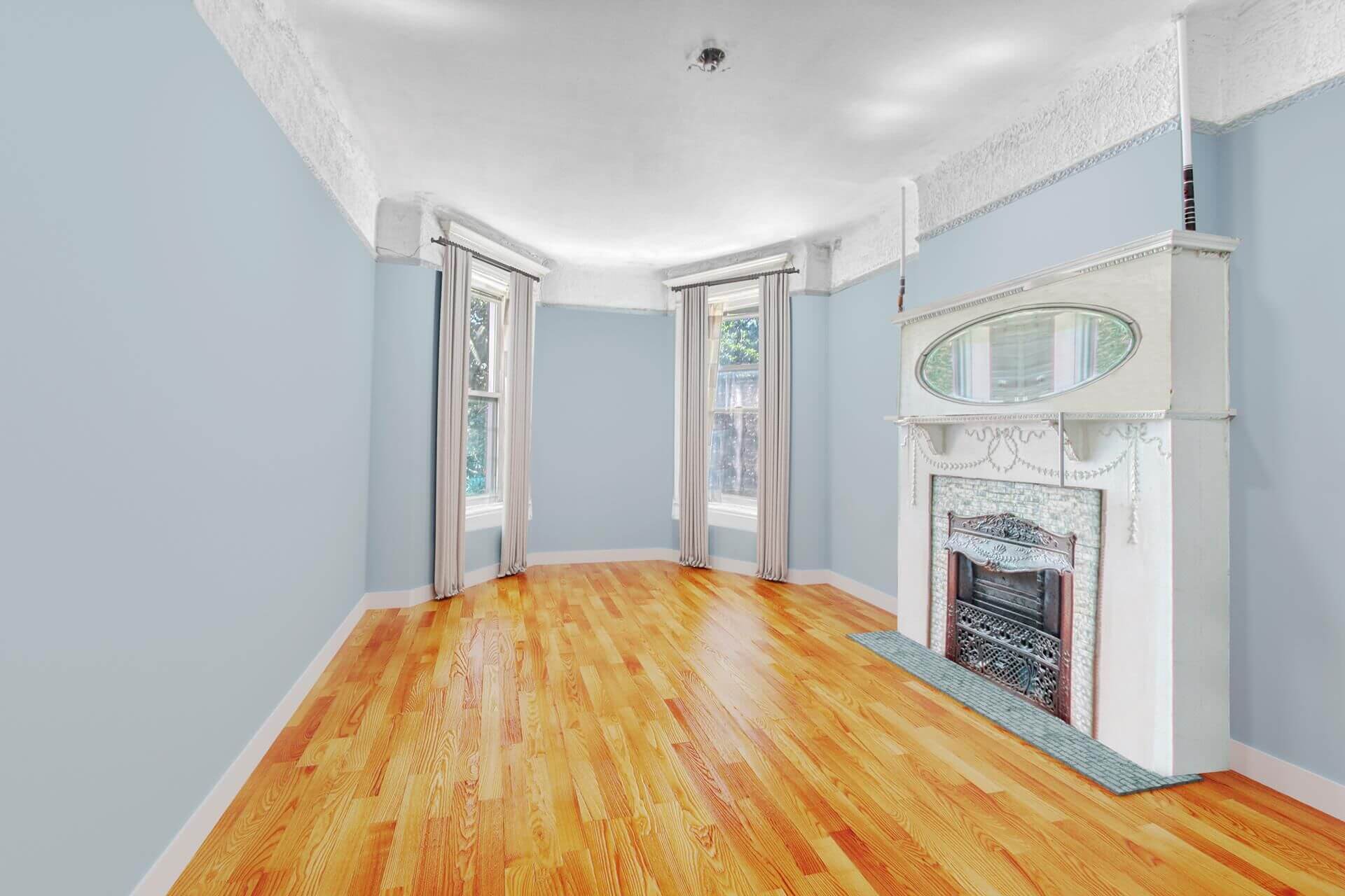 parlor with a white mantel with mirror