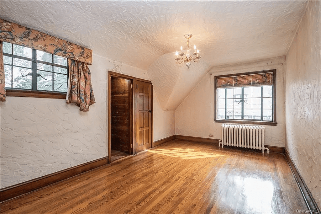 bedroom with two exposures and a wood lined closet