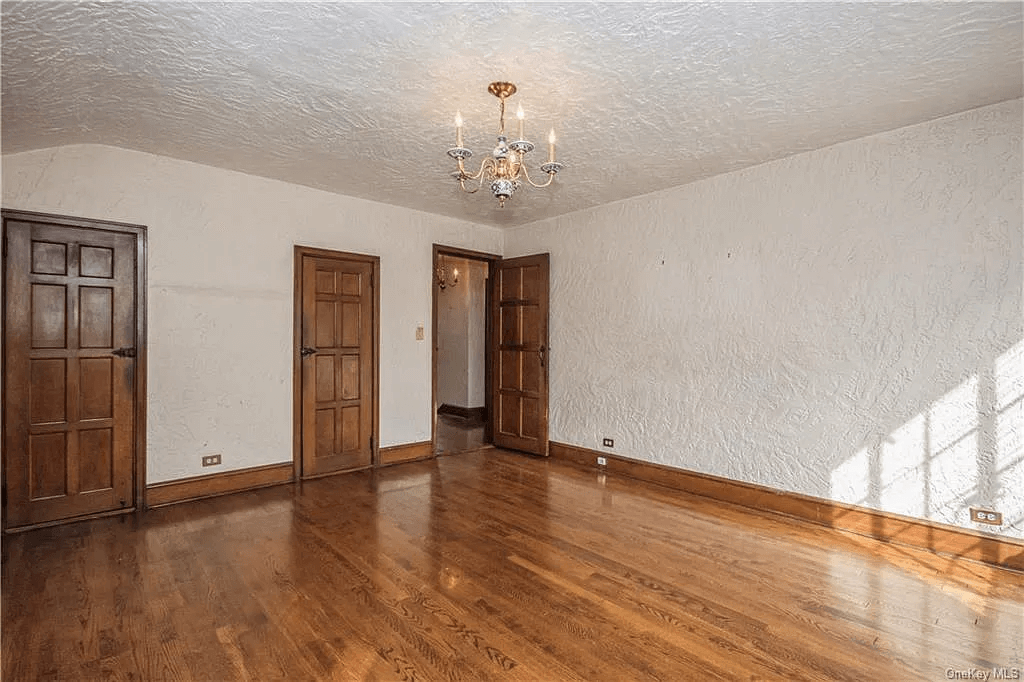 bedroom with wood floors and white walls