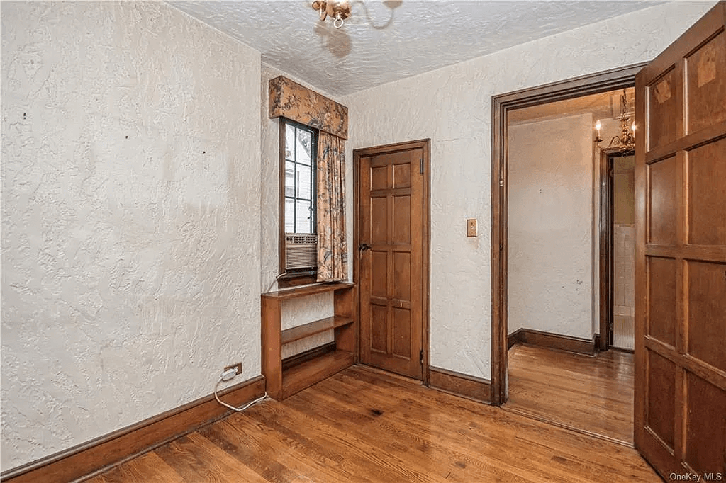 bedroom with wood floors and a closet