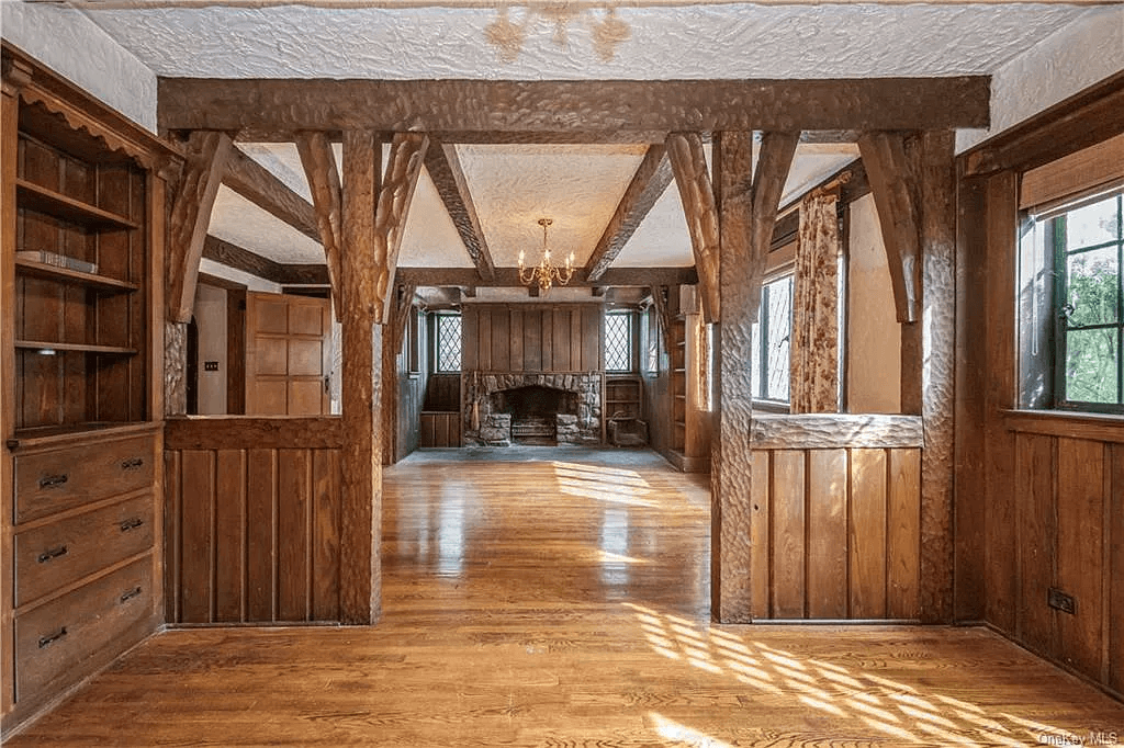 view from dining room to stone fireplace in the living room