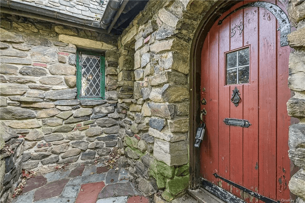 arched front door painted red with original hardware and mail slot