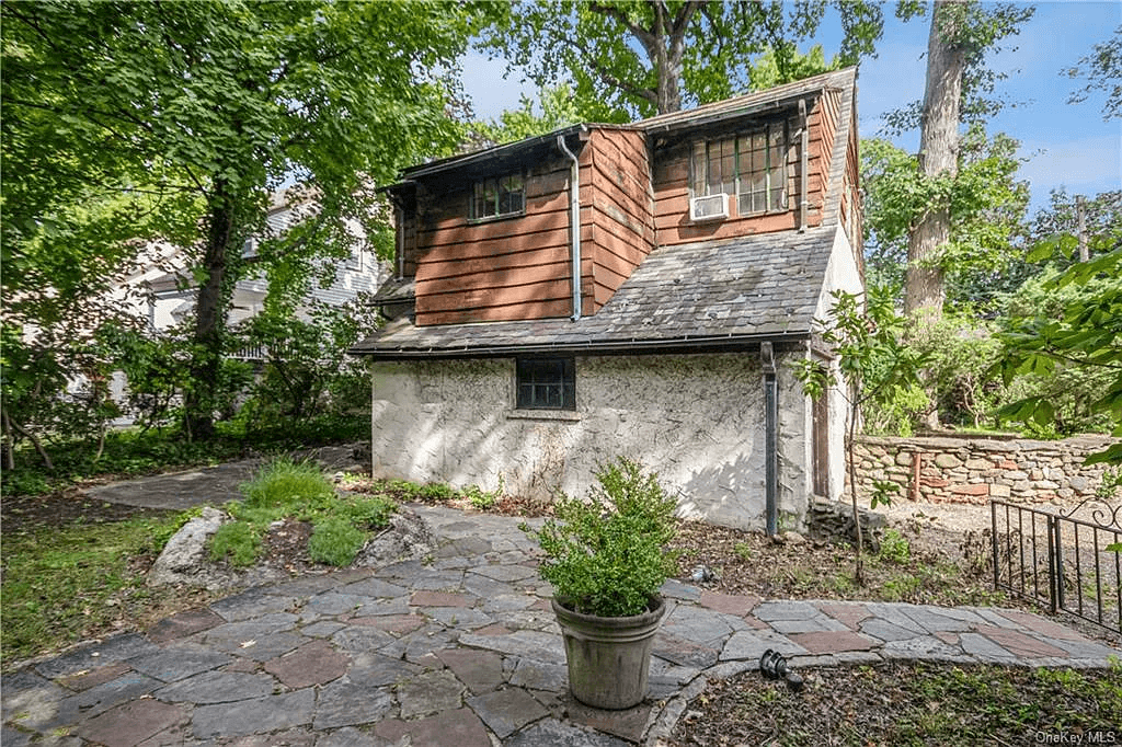 rear facade with stucco lower floor and wood sided upper level