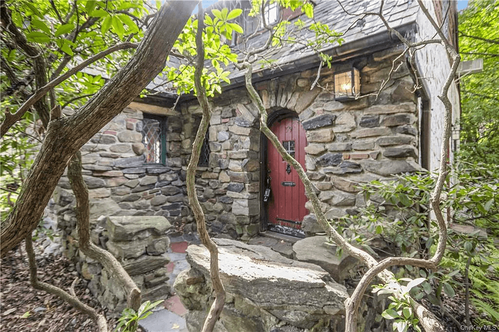 stone entrance with an arched red door