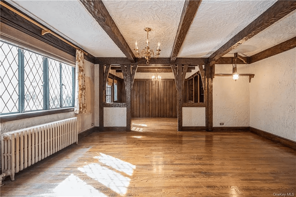 living room with half wall separating it from dining