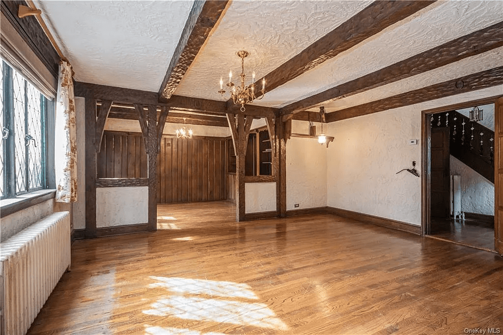 living room with beamed ceiling and wood floors