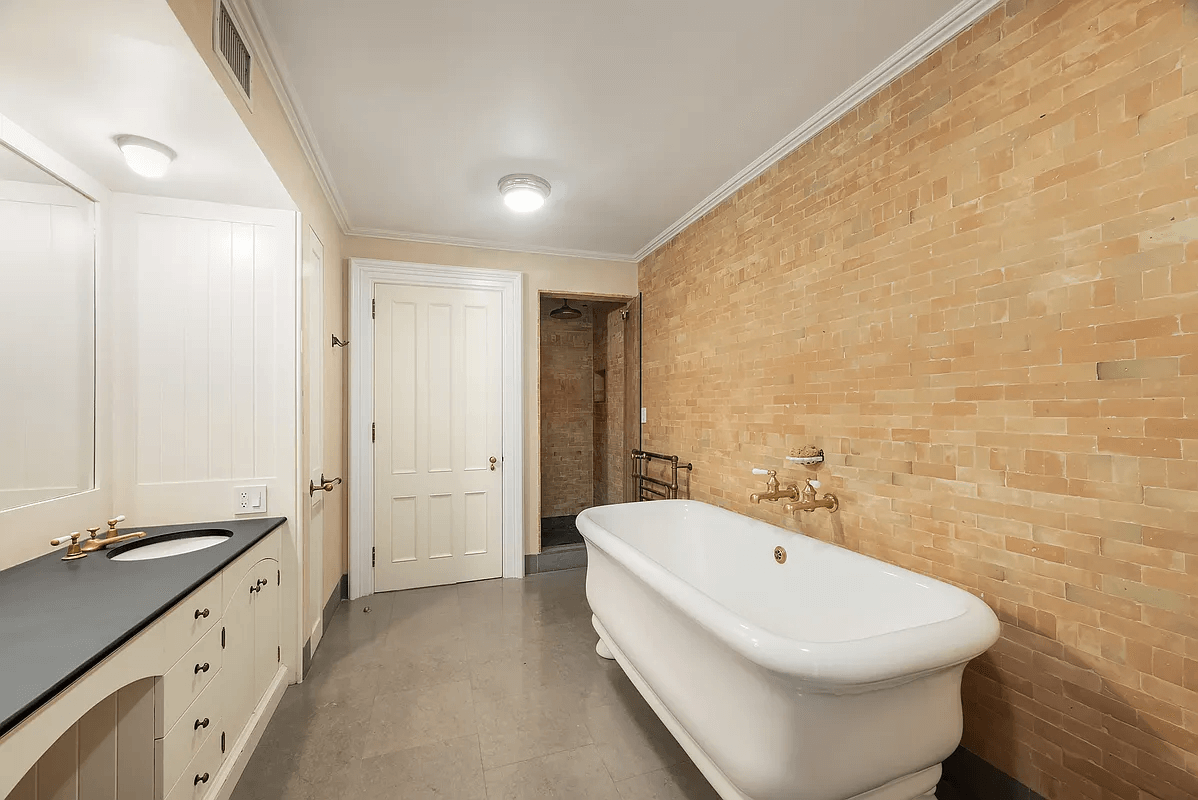 bathroom on garden level with glass shower, soaking tub