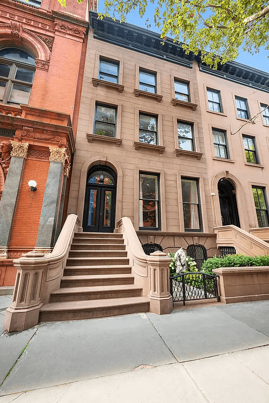 exterior of the brownstone with stoop, front garden space and a view of the adjoining center for brooklyn history