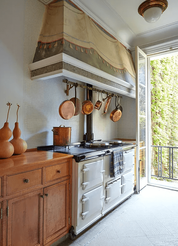 kitchen in the duplex with hood over an aga stove