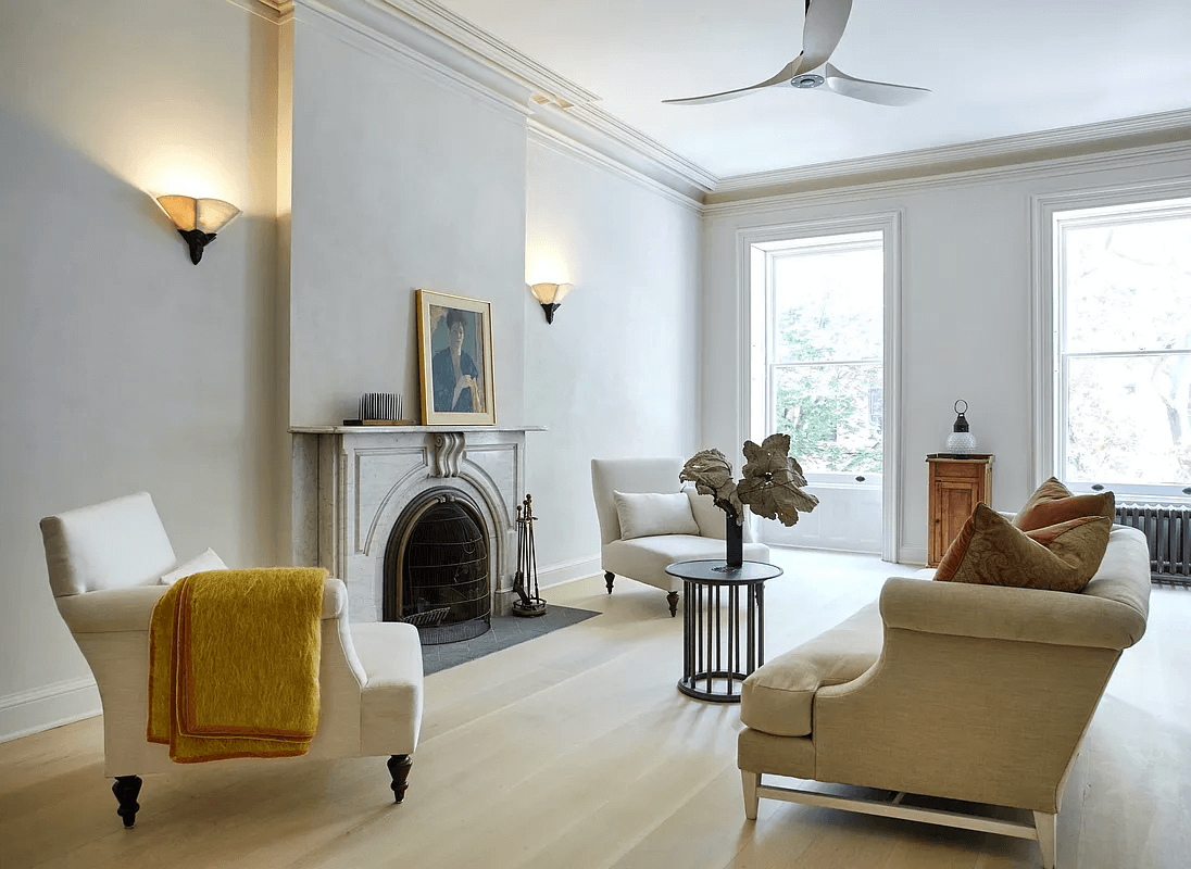 marble mantel and pale wood floors in middle duplex