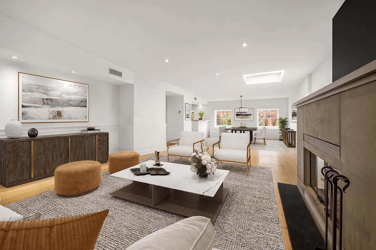 living area in top floor apartment with recessed lighting, mantel and skylight