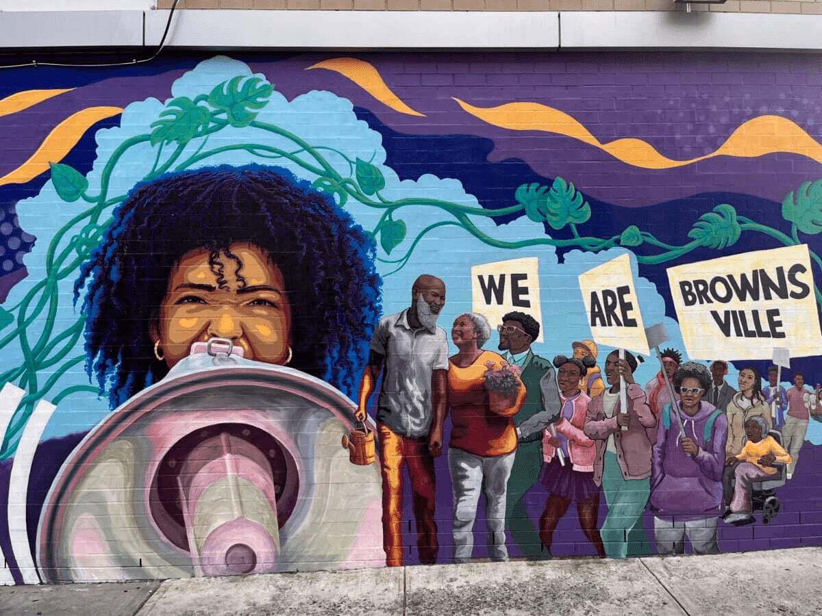 groundswell mural in bright colors with signs we are brownsville
