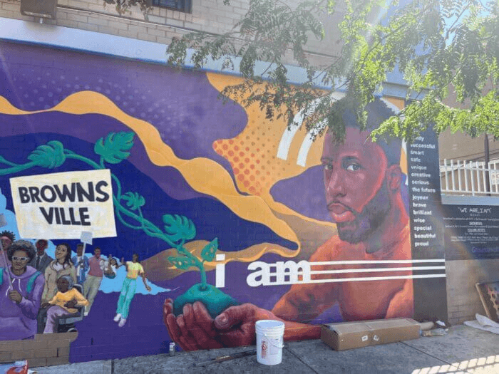 a view of the figurative mural seen from the sidewalk