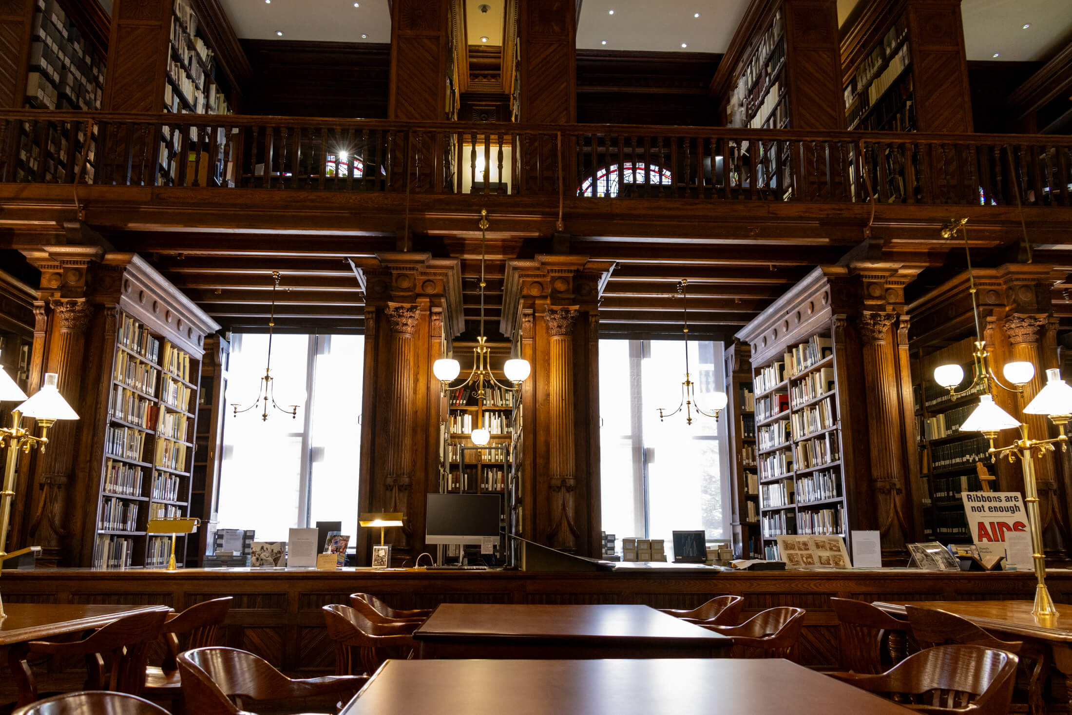 the library interior with wood bookshelves and tables for researchers