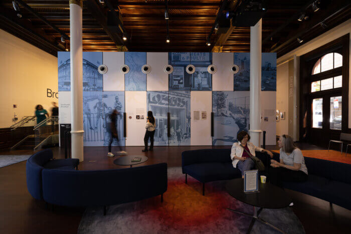 first floor space with sofas and historic images on the wall