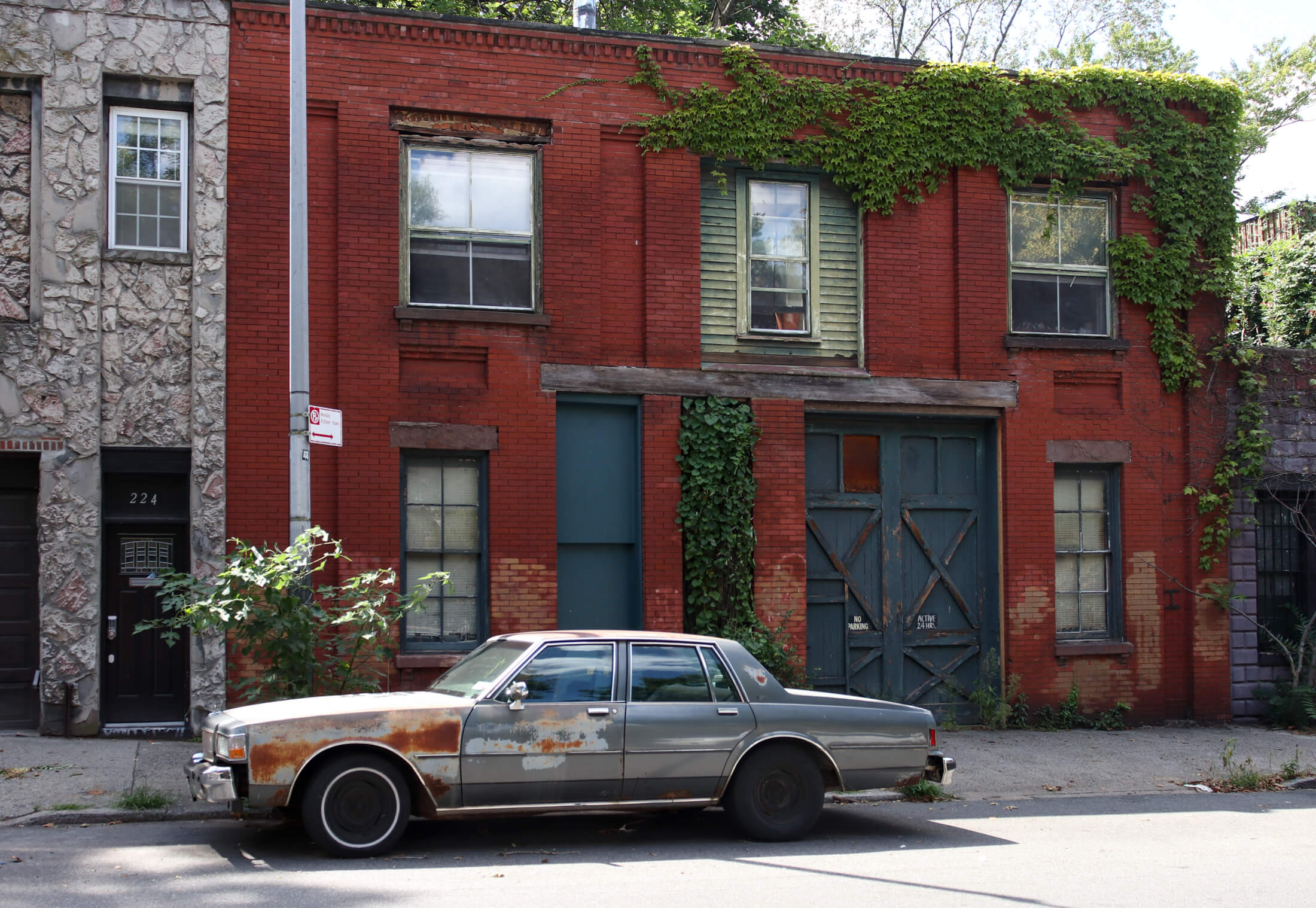 brooklyn - car parked in front of a vine covered brick building