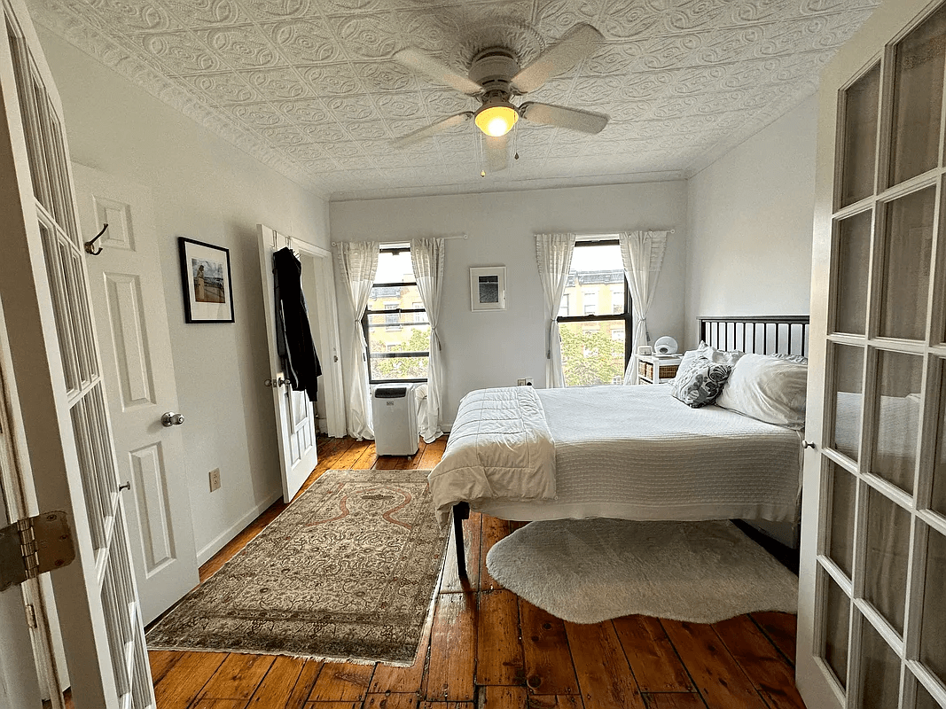 bedroom with two windows, tin ceiling
