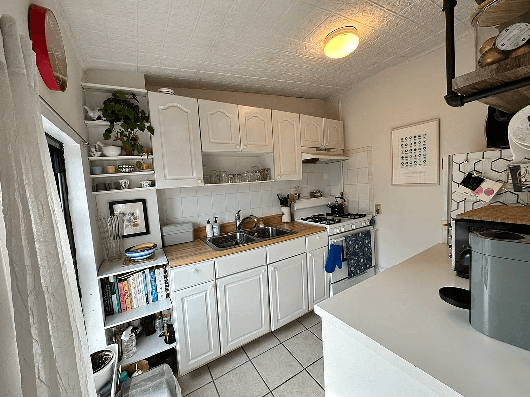 kitchen with white cabinets and tin ceiling