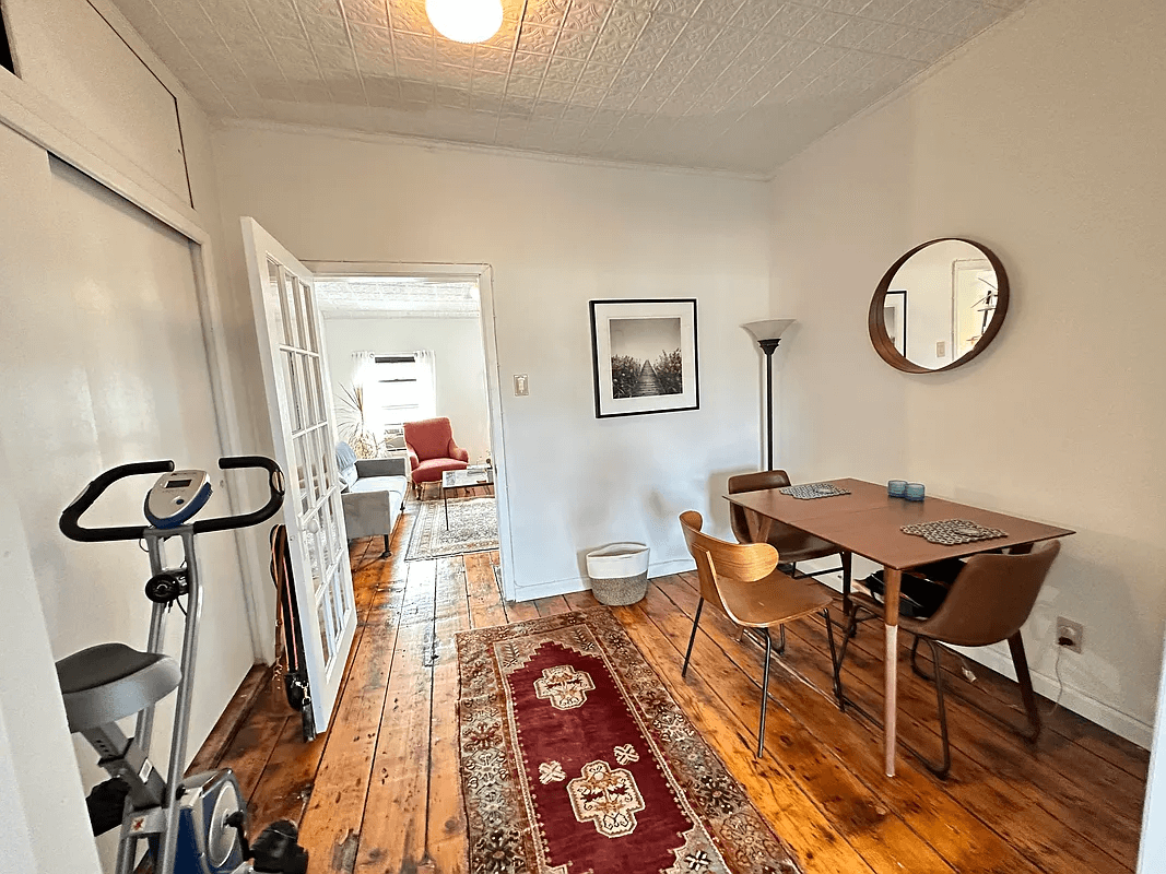 middle room with tin ceiling and glass paned door to living room