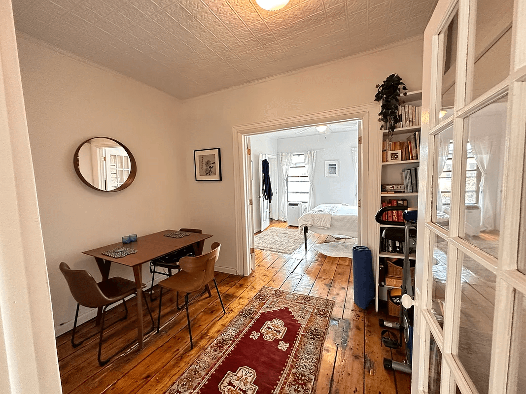 middle room with tin ceiling and wood floor