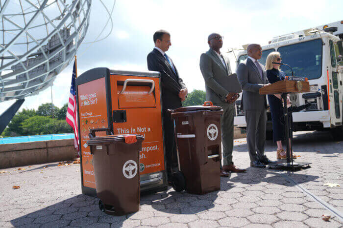 brown composting bins at a press event with mayor adams