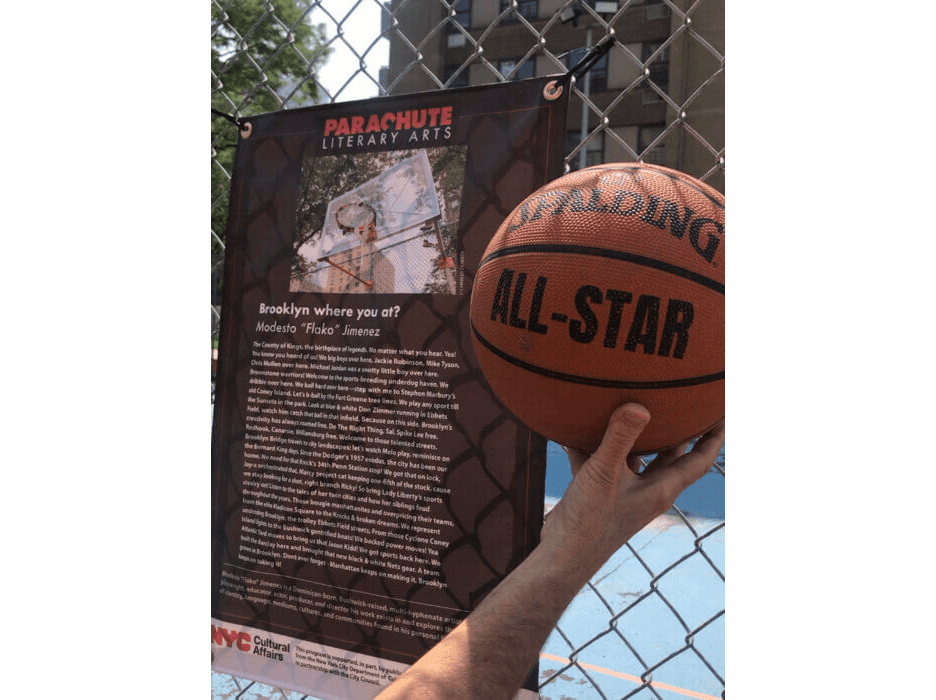 a poem hung on a fence around a basketball court