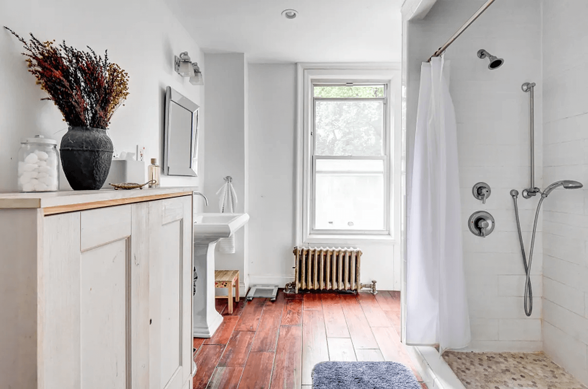 bathroom with walk in shower and white pedestal sink