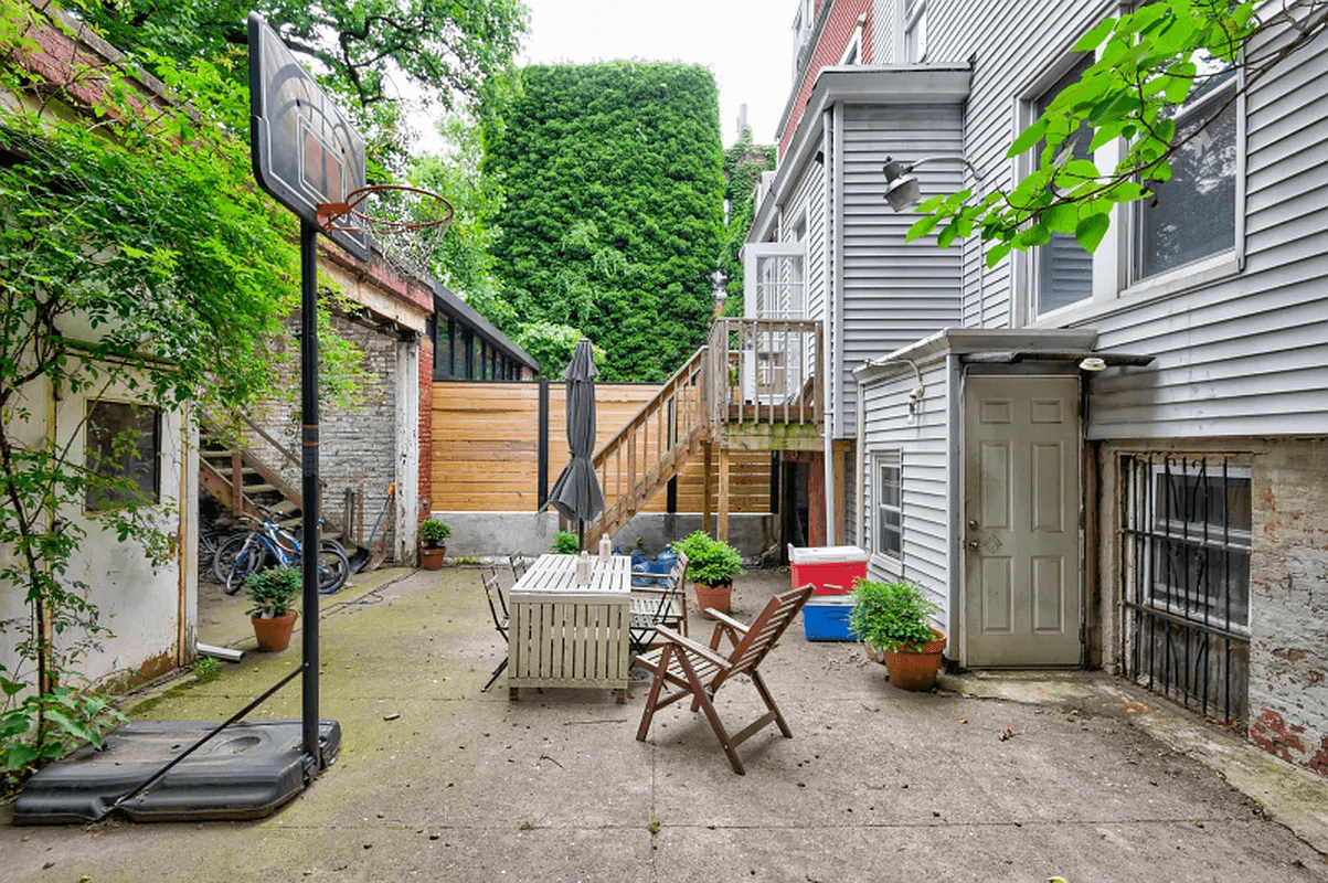 concrete paved rear yard with view of the garage