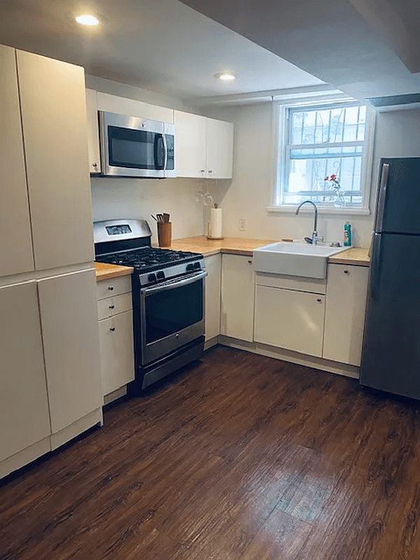 kitchen on lower level with apron sink and recessed lighting