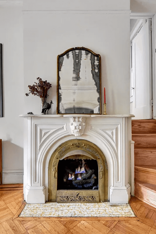 marble mantel next to a staircase